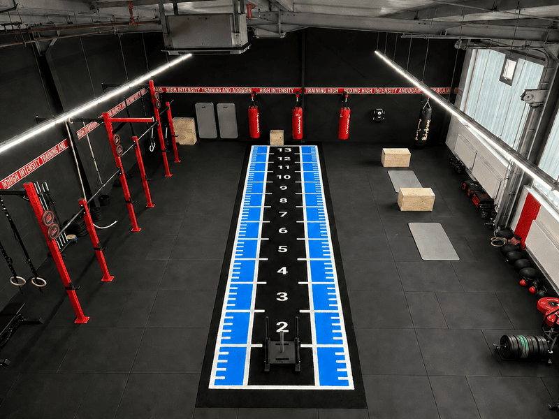 Gym turf undergoing physical dimension inspection in a factory lab